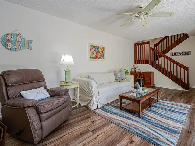 a living room with furniture a rug and a window