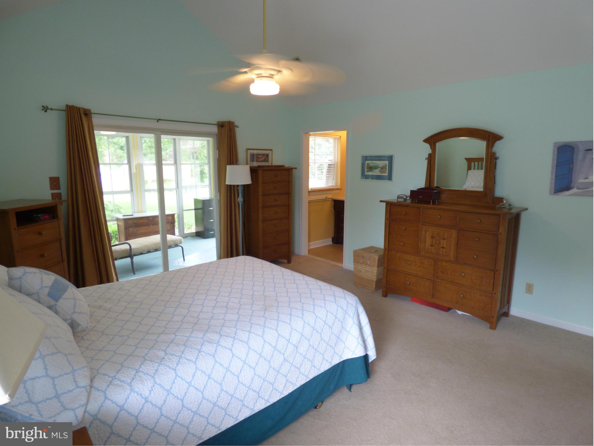 105 Myers Road Chestertown, MD 21620 - Photo 16 of 30 a bedroom with a bed and a dresser with mirror