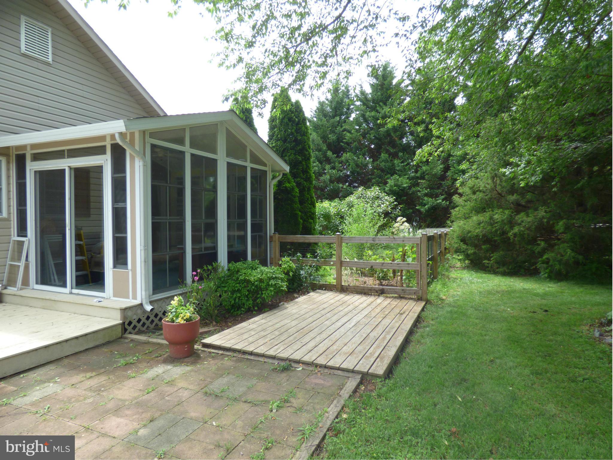 105 Myers Road Chestertown, MD 21620 - Photo 7 of 30 a view of a backyard with table and chairs and potted plants