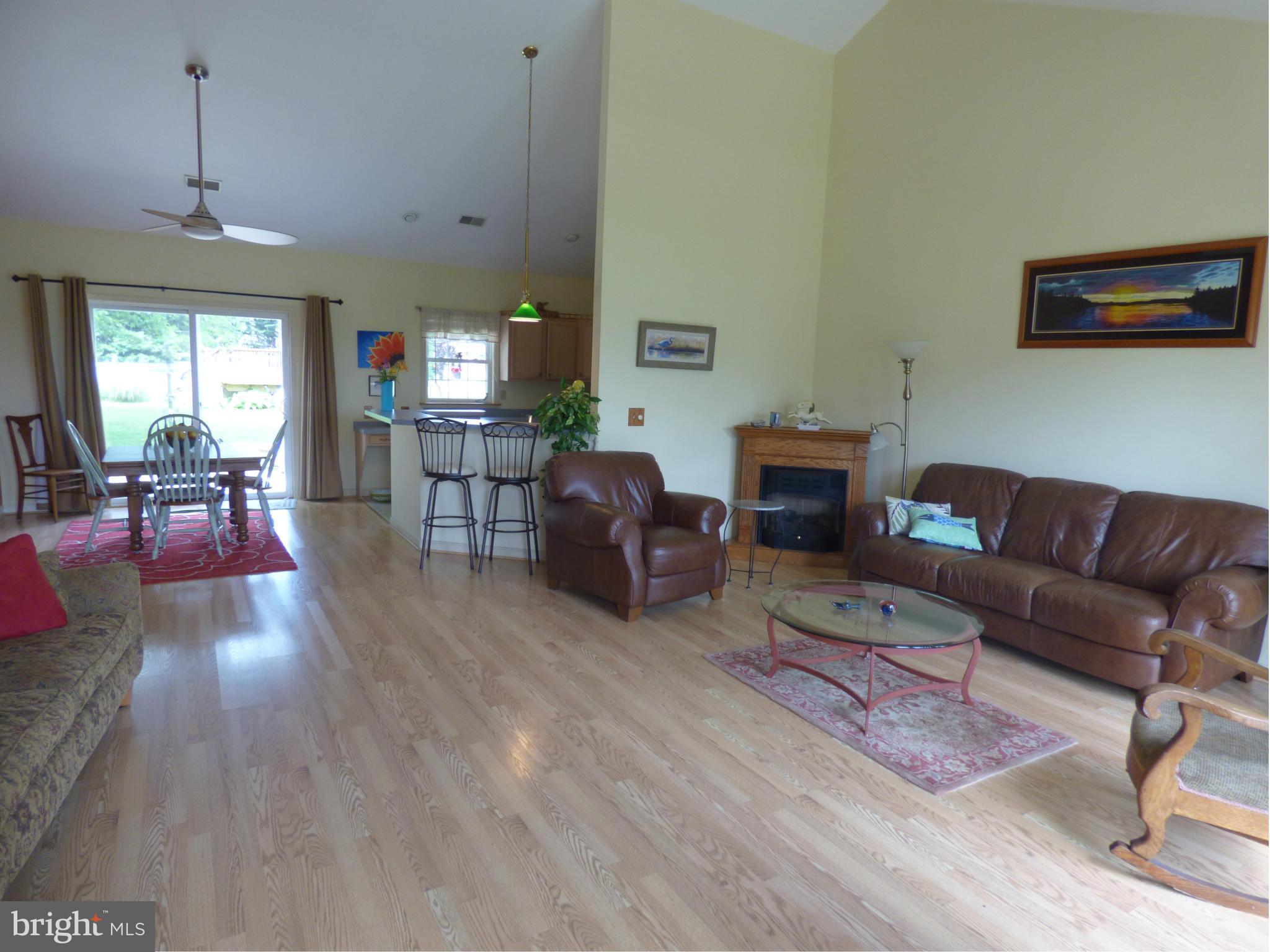 105 Myers Road Chestertown, MD 21620 - Photo 8 of 30 a living room with furniture a fireplace and a dining table with wooden floor