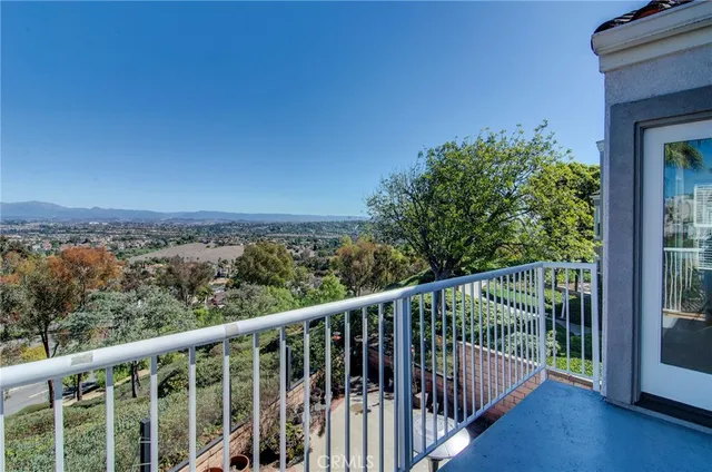 a view of a balcony with wooden fence and floor