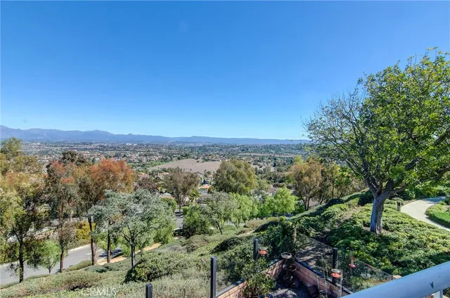 a view of a city with lush green forest