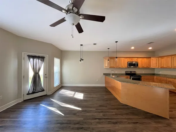 a view of kitchen with sink and wooden floor
