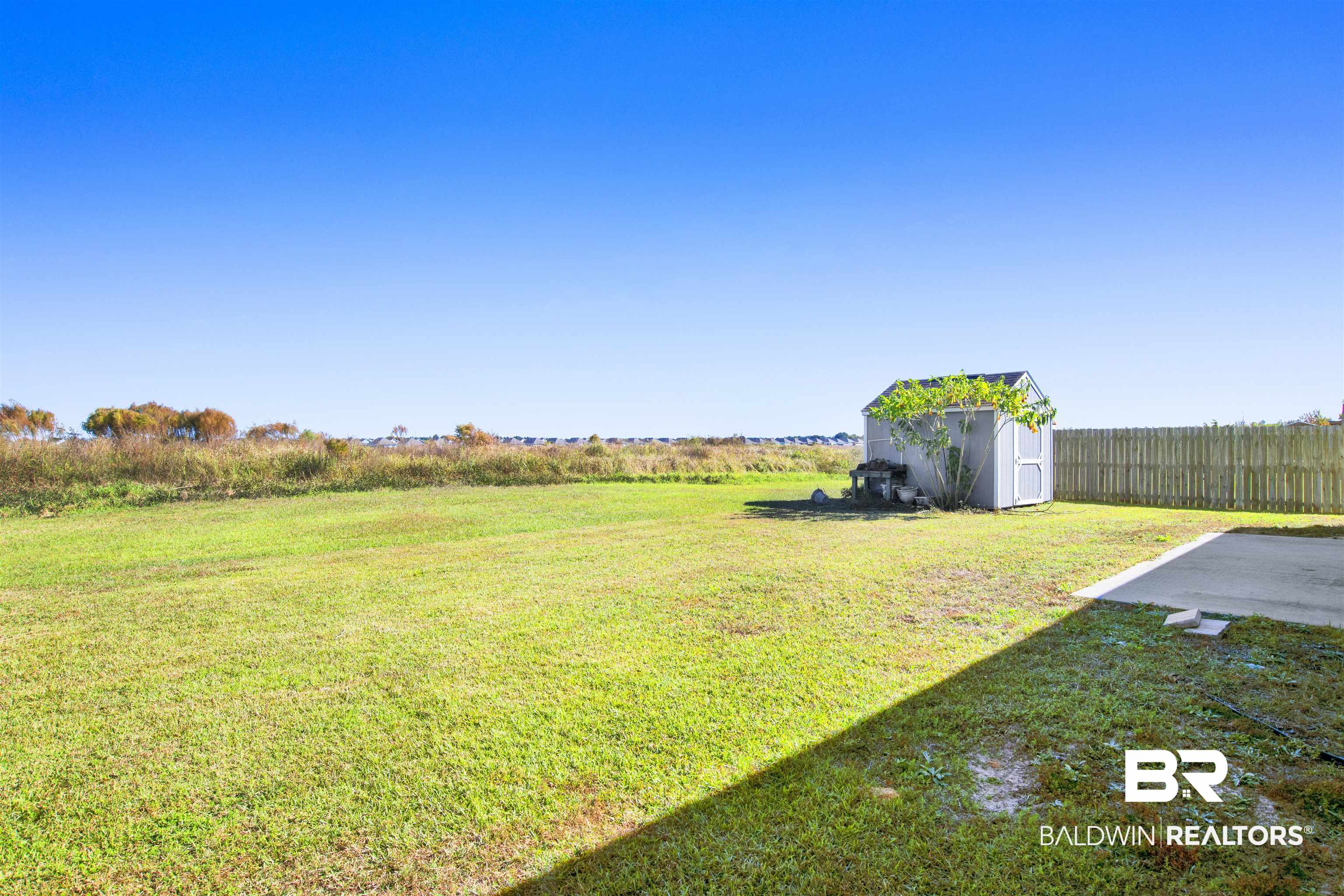 6926 Crimson Ridge Street Gulf Shores, AL 36542 - Photo 16 of 18 View of yard featuring a shed