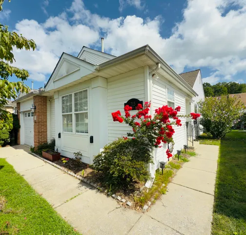a front view of house with flower around