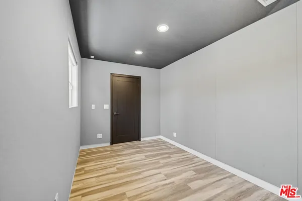 a view of a room with wooden floor and closet