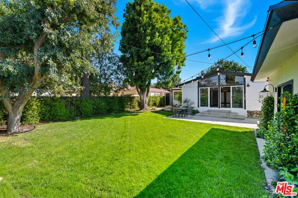 a front view of a house with a garden and yard