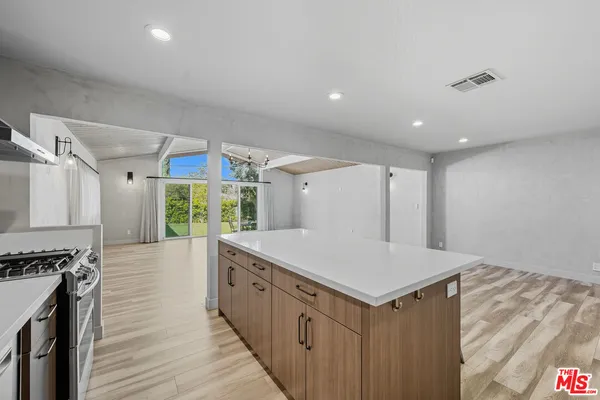 a kitchen with sink cabinets and wooden floor