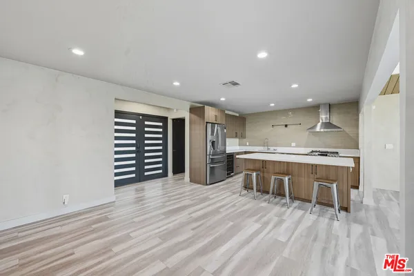 a kitchen with a sink and wooden cabinets