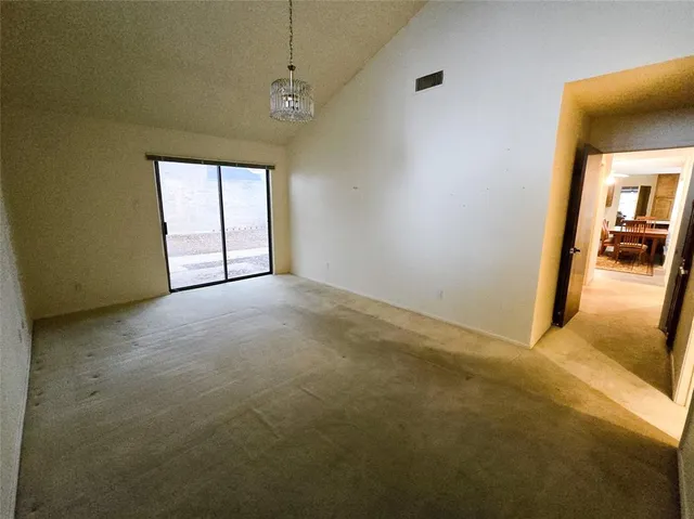 a view of a livingroom with wooden floor and a ceiling fan