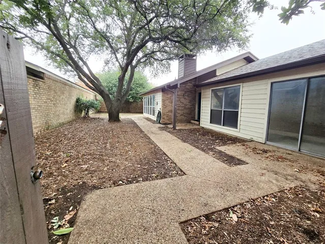 a backyard of a house with large tree