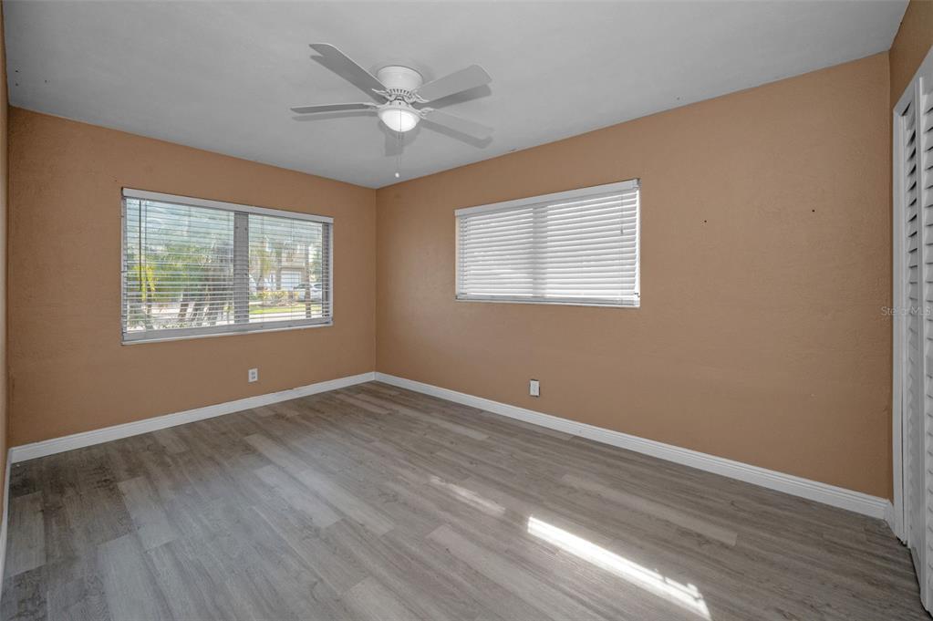 2476 Coronado Way Dunedin, FL 34698 - Photo 14 of 81 a view of an empty room with wooden floor and a window
