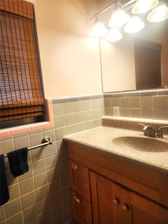 2476 Coronado Way Dunedin, FL 34698 - Photo 16 of 81 a bathroom with a sink and a shower