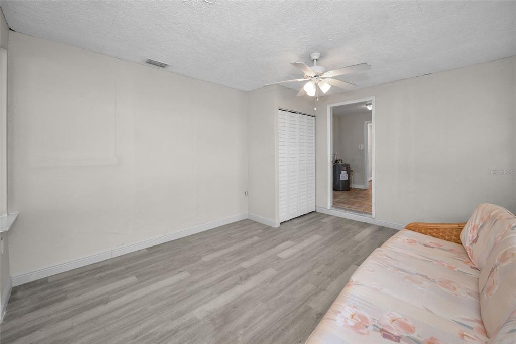 2476 Coronado Way Dunedin, FL 34698 - Photo 18 of 81 a view of a livingroom with a ceiling fan and wooden floor