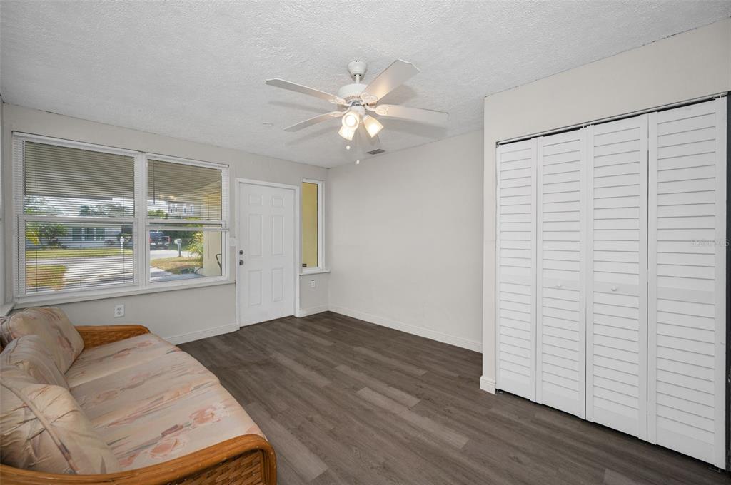 2476 Coronado Way Dunedin, FL 34698 - Photo 19 of 81 wooden floor in an empty room with a window