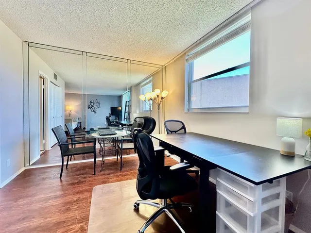 a view of a workspace with furniture and window