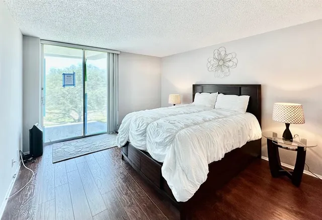 a living room with a bed furniture and a large window