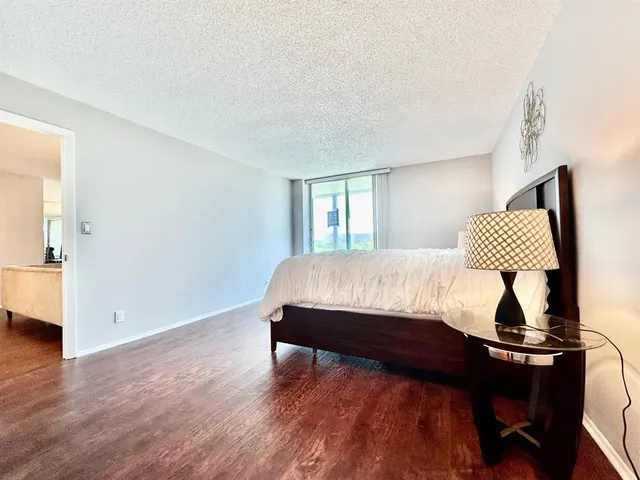 a en suite bathroom with a granite countertop sink and a mirror