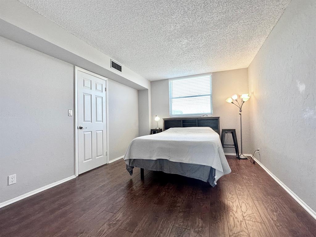 5301 Northwest 2nd Avenue, Unit 408 Boca Raton, FL 33487 - Photo 22 of 32 a bedroom with a bed and a window