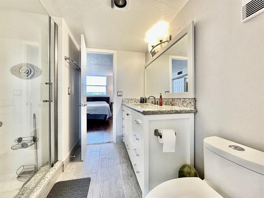 5301 Northwest 2nd Avenue, Unit 408 Boca Raton, FL 33487 - Photo 24 of 32 a bathroom with a sink a toilet and shower