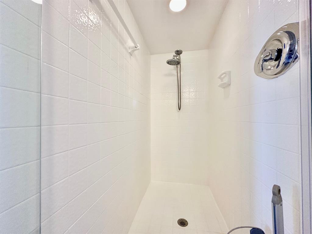 5301 Northwest 2nd Avenue, Unit 408 Boca Raton, FL 33487 - Photo 25 of 32 a bathroom with a shower and a window