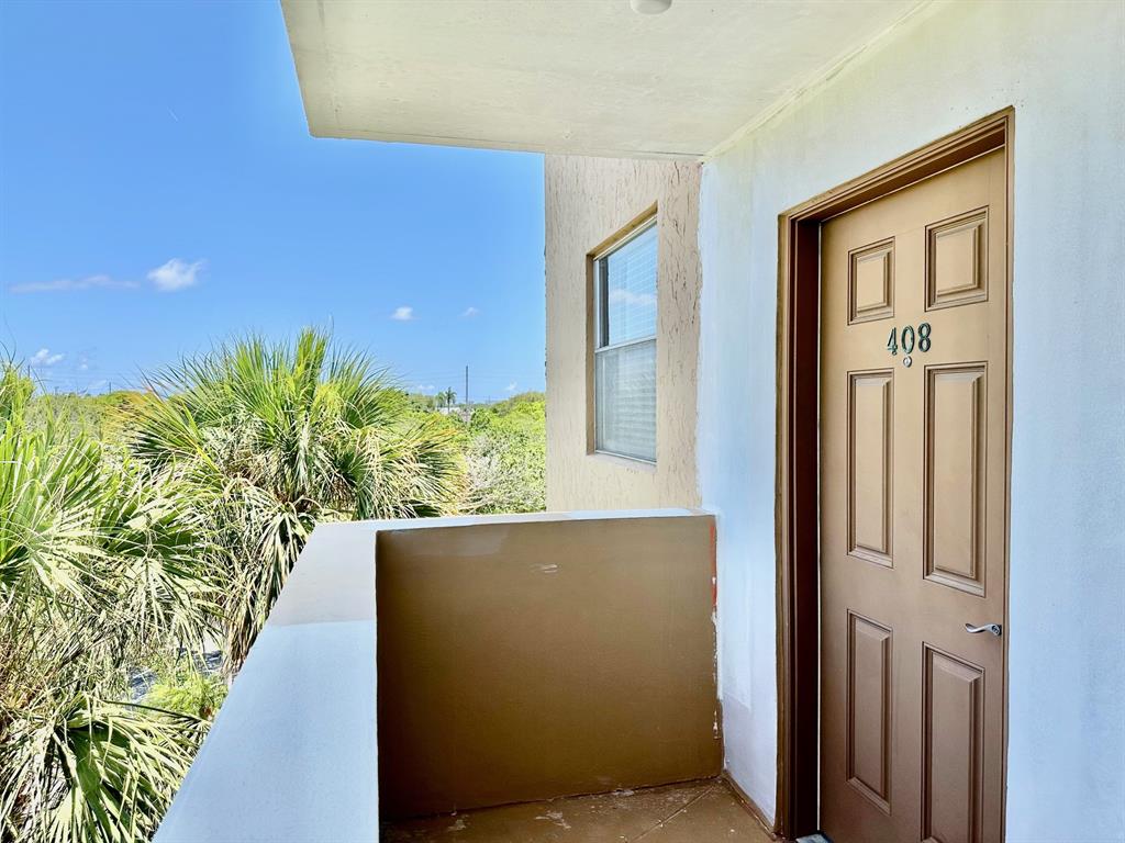 5301 Northwest 2nd Avenue, Unit 408 Boca Raton, FL 33487 - Photo 28 of 32 a view of a potted plants in front of a house
