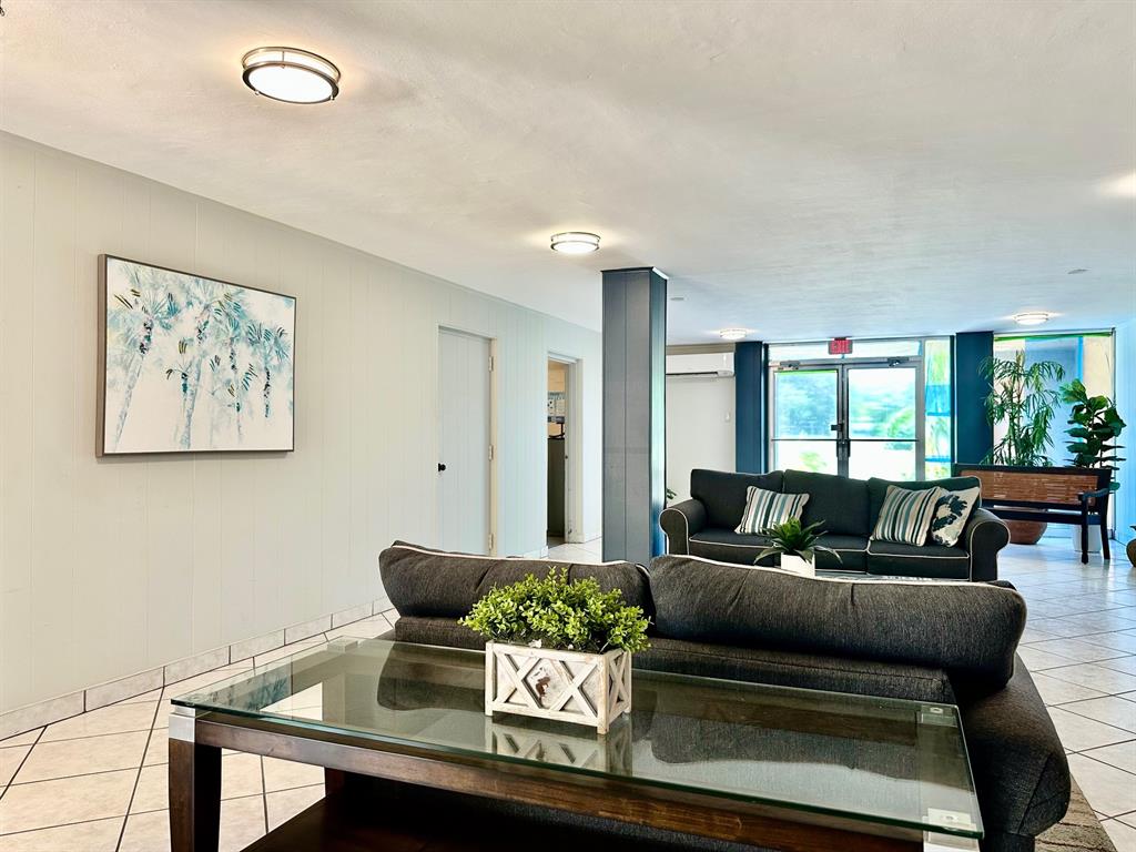 5301 Northwest 2nd Avenue, Unit 408 Boca Raton, FL 33487 - Photo 31 of 32 a living room with furniture and a large window