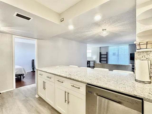 a kitchen with granite countertop a sink and a stove