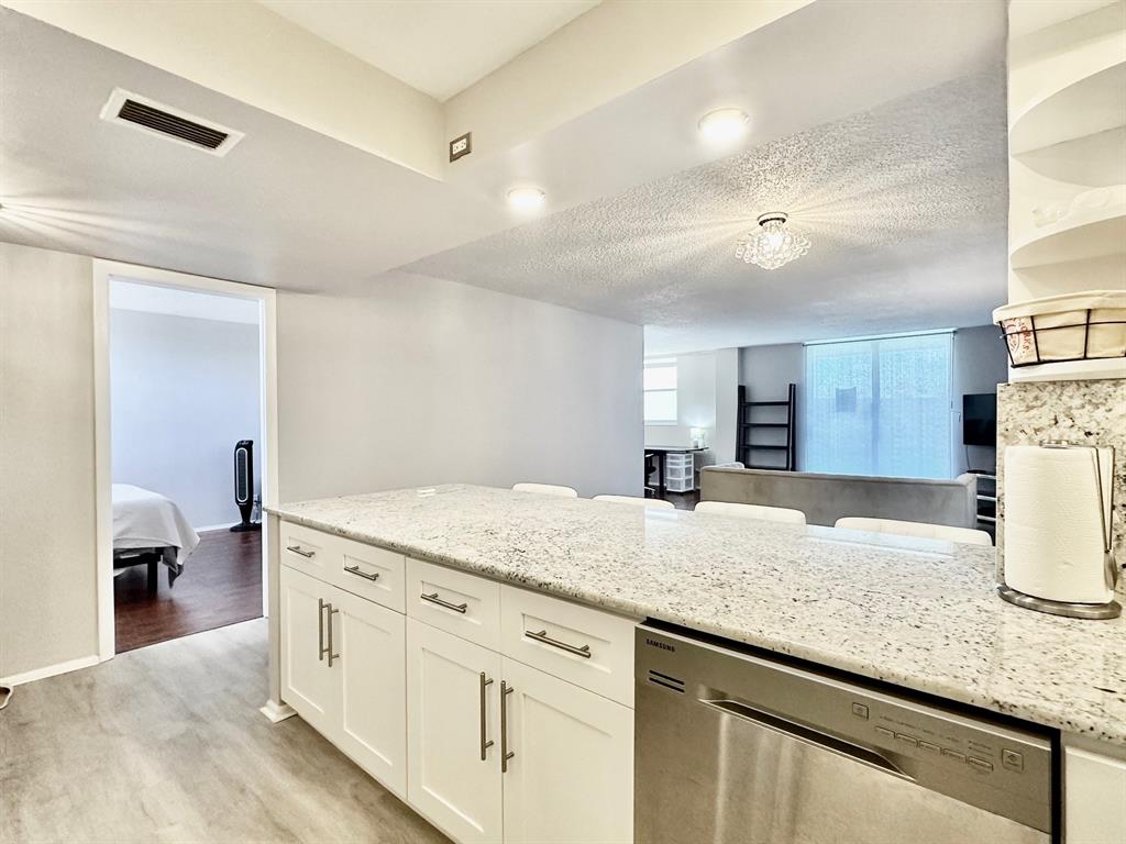 5301 Northwest 2nd Avenue, Unit 408 Boca Raton, FL 33487 - Photo 5 of 32 a kitchen with granite countertop a sink and a stove