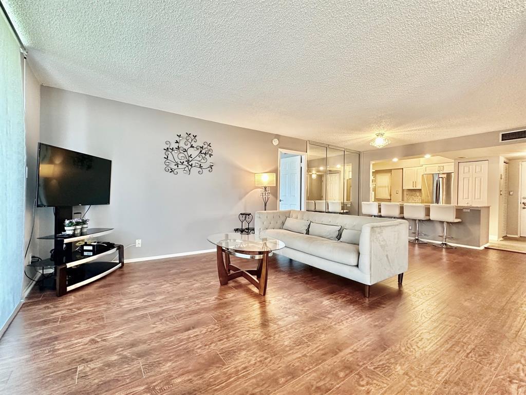 5301 Northwest 2nd Avenue, Unit 408 Boca Raton, FL 33487 - Photo 6 of 32 a living room with furniture and a flat screen tv