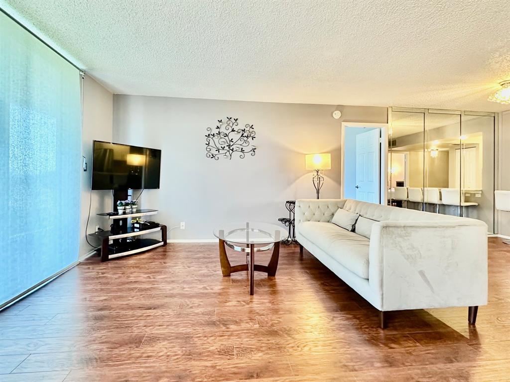 5301 Northwest 2nd Avenue, Unit 408 Boca Raton, FL 33487 - Photo 7 of 32 a living room with furniture and a flat screen tv