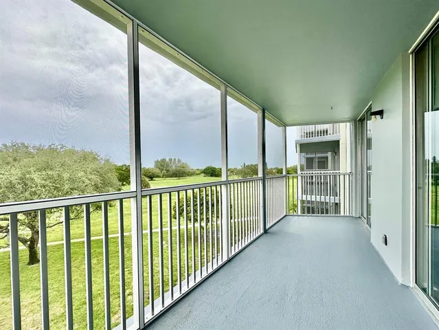 a view of a livingroom with furniture and a window