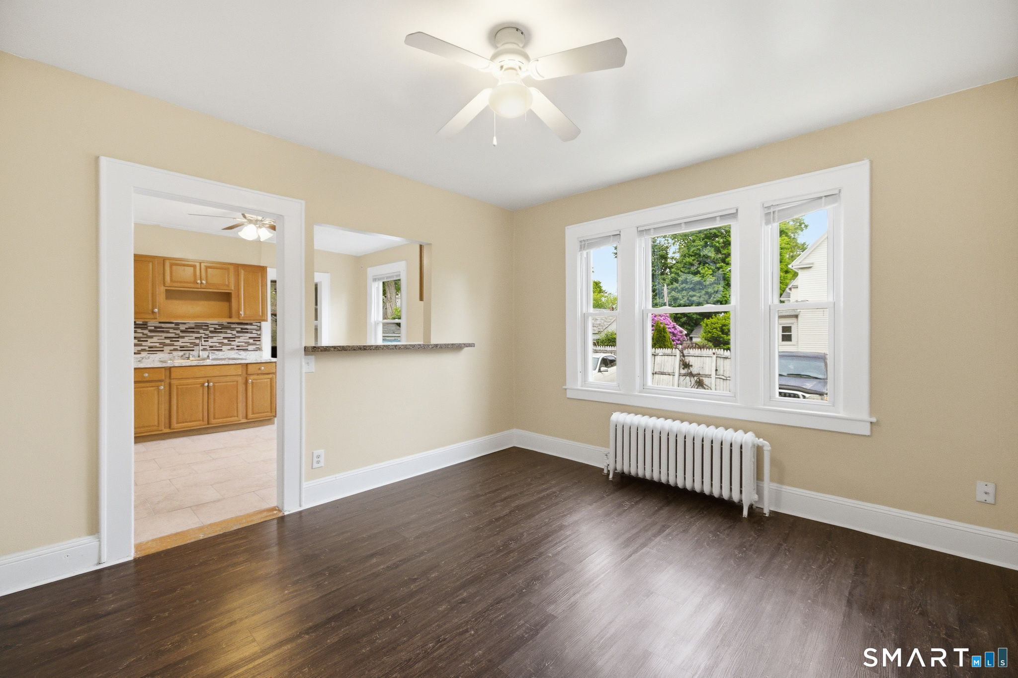 76 Harold Street Hartford, CT 06112 - Photo 1 of 12 a view of an empty room with window and wooden floor