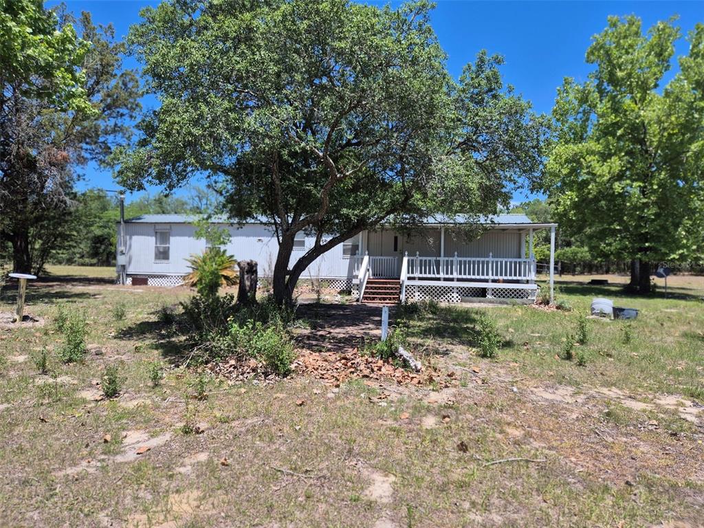 11651 Northeast 73rd Lane Bronson, FL 32621 - Photo 1 of 39 a house view with a backyard space