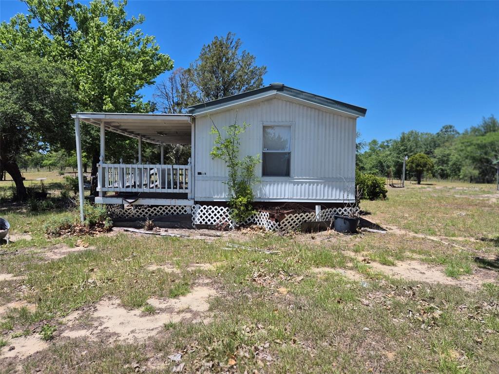 11651 Northeast 73rd Lane Bronson, FL 32621 - Photo 2 of 39 front view of a house with a yard