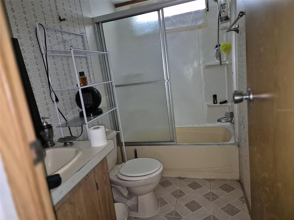 11651 Northeast 73rd Lane Bronson, FL 32621 - Photo 26 of 39 a bathroom with a sink a toilet and shower