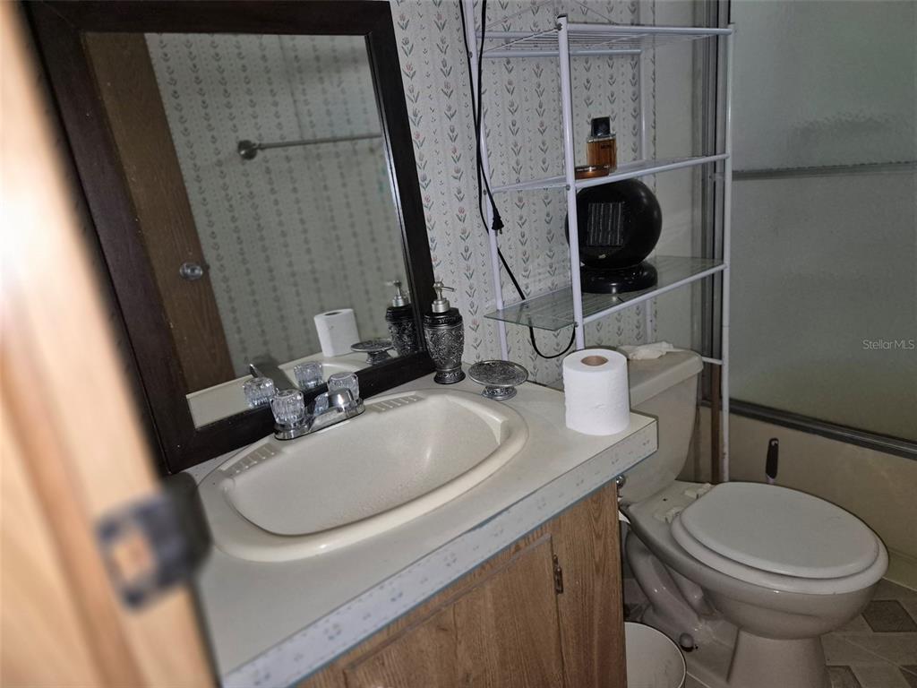 11651 Northeast 73rd Lane Bronson, FL 32621 - Photo 27 of 39 a bathroom with a sink and a toilet