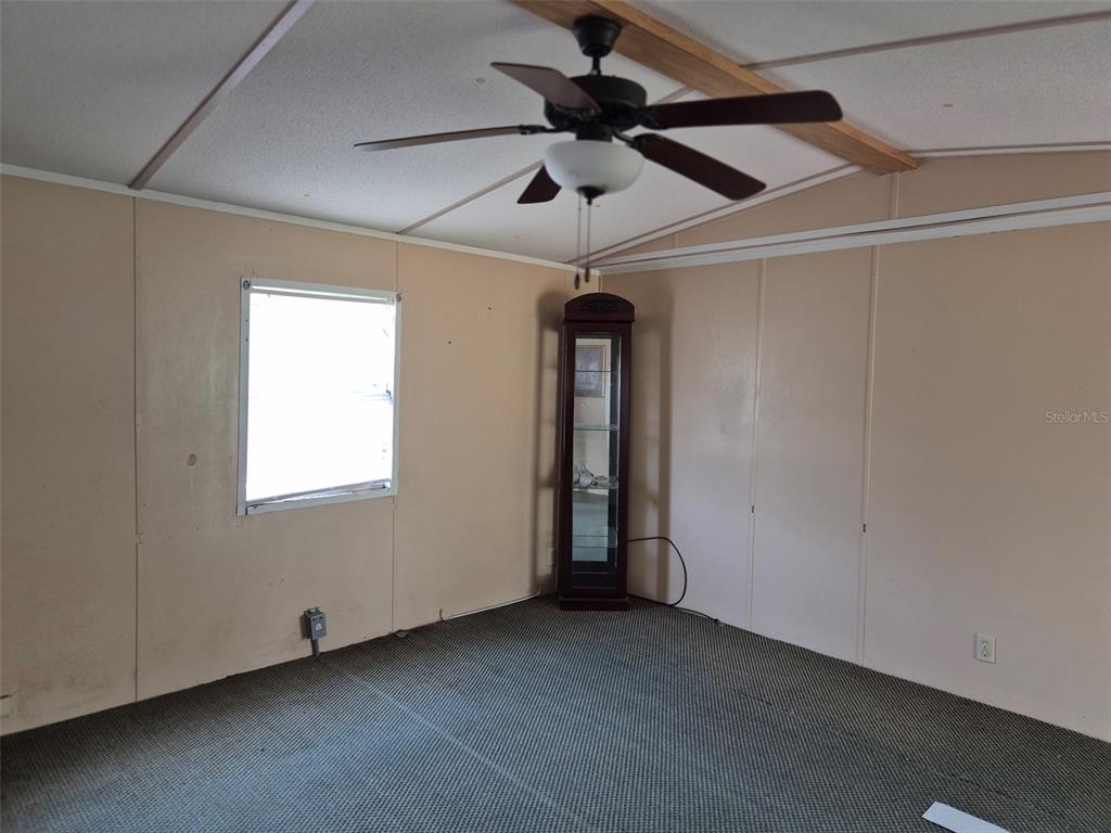 11651 Northeast 73rd Lane Bronson, FL 32621 - Photo 30 of 39 an empty room with a ceiling fan and window