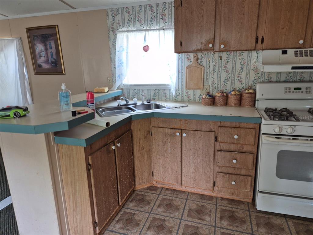 11651 Northeast 73rd Lane Bronson, FL 32621 - Photo 32 of 39 a kitchen with a sink stove and cabinets