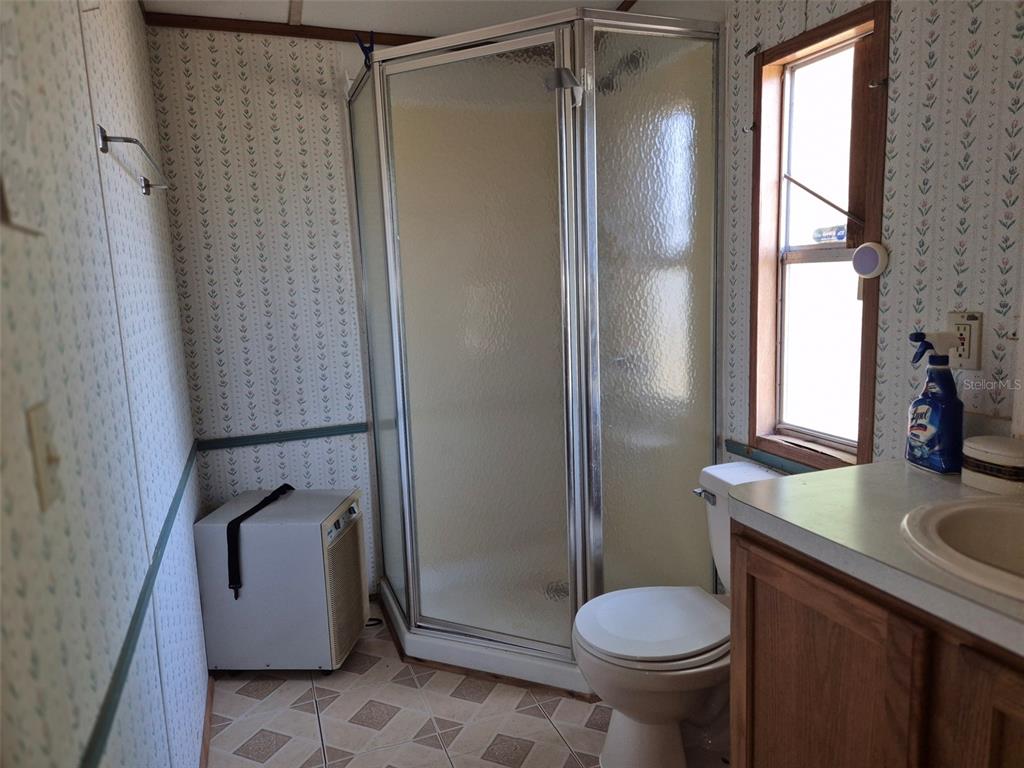 11651 Northeast 73rd Lane Bronson, FL 32621 - Photo 37 of 39 a bathroom with a sink toilet and shower