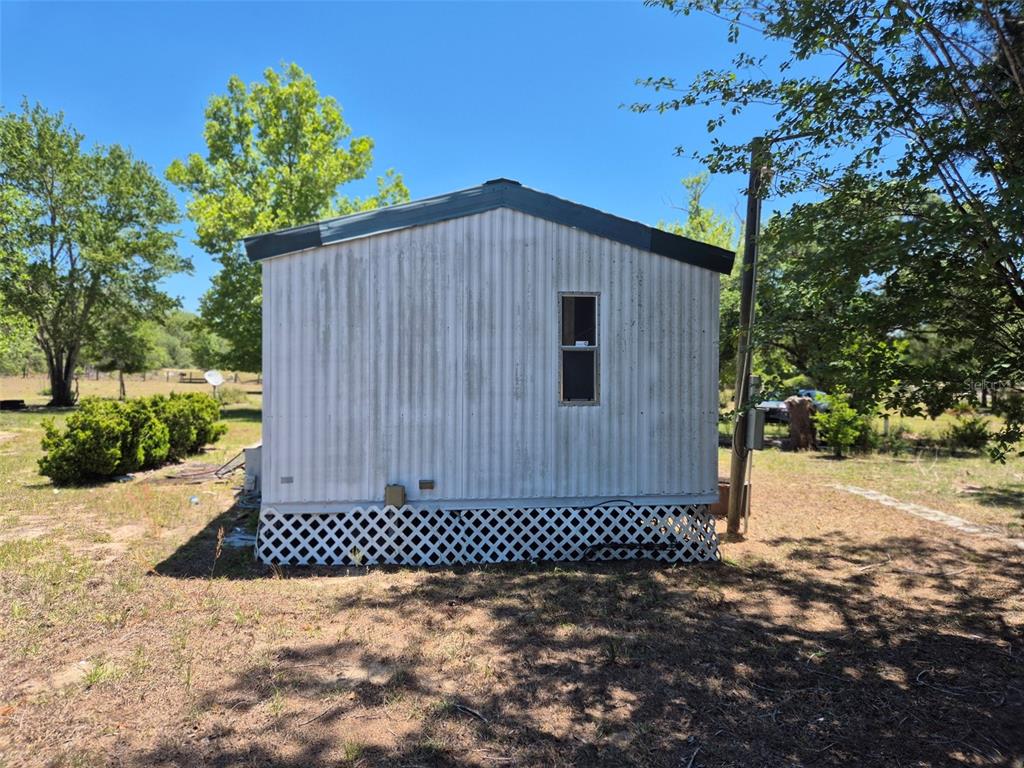 11651 Northeast 73rd Lane Bronson, FL 32621 - Photo 6 of 39 a view of a backyard with a house