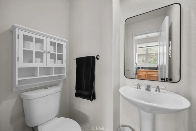 a bathroom with a sink toilet and mirror
