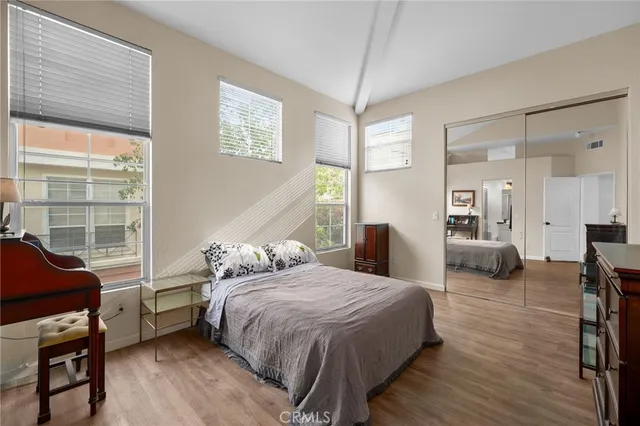 a bedroom with a bed a couch and dresser