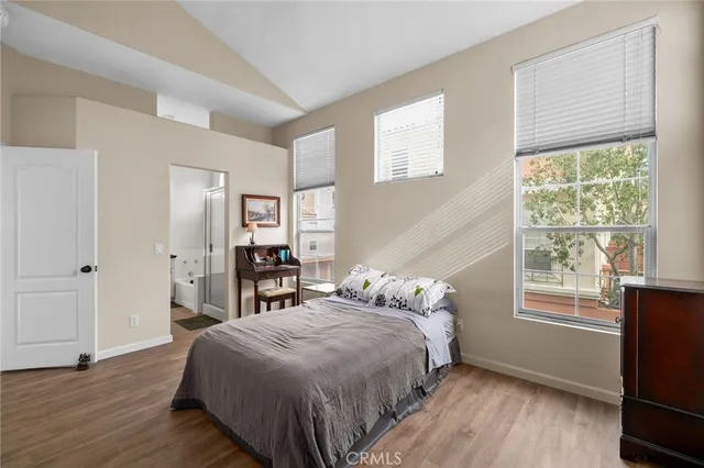 a bed sitting in a bedroom next to a window