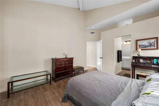 a bedroom with a bed and a desk