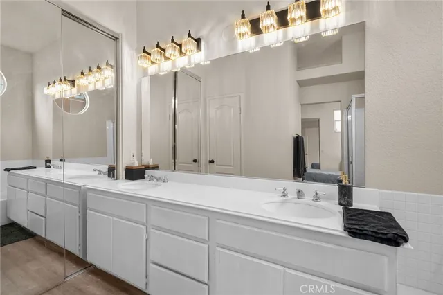a bathroom with a double vanity sink and a mirror