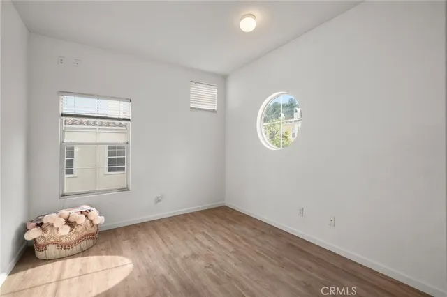 a room with a window and wooden floor