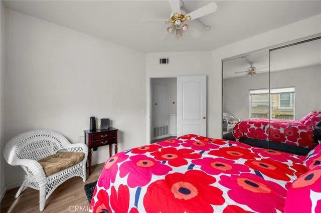 a bedroom with a large bed and a chandelier