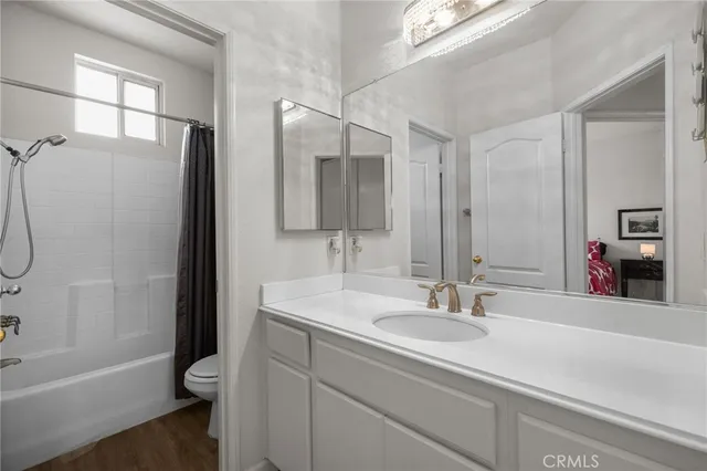 a bathroom with a sink a tub and a mirror