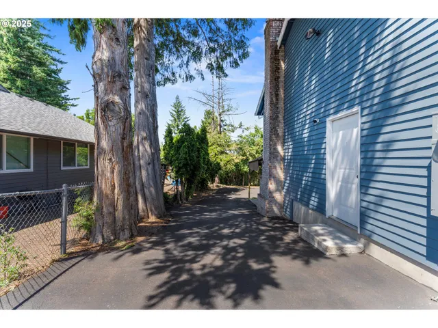 a view of a backyard with a tree